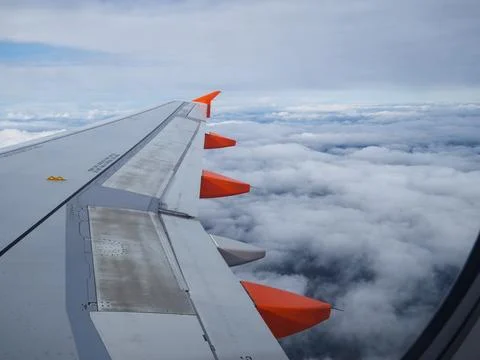 Passenger views wing soaring above cloud layer Foto stock