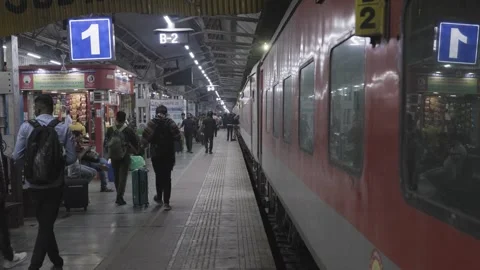 Passenger walking to catch the standing train at evening at railway station Stock Footage 285300123