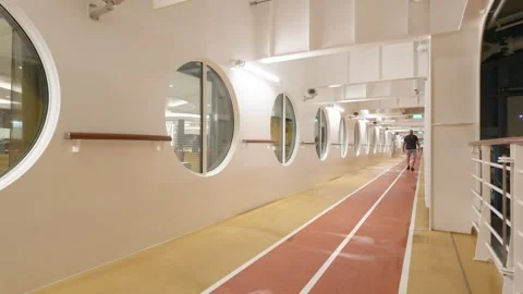 Passenger walking on an indoor running track corridor on a cruise ship deck Stock Footage 346556406