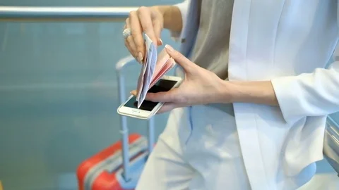 Passenger in a white suit checks the documents and holding a phone Stock Footage 72064611