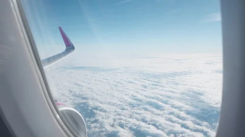 Passenger window view of airplane wing and engine flying over clouds Stock-Footage 325050022