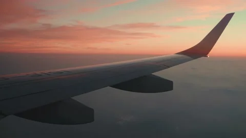 Passenger window view of commercial aircraft at sunset Stockbeeldmateriaal 165277780