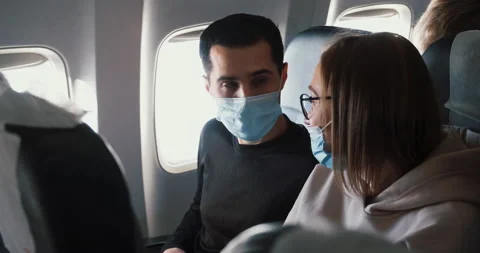 Passengers aboard using masks due to COVID-19 pandemic epidemic when travel Stock Footage 150431576