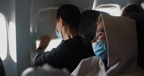 Passengers aboard using masks due to COVID-19 pandemic epidemic when travel Stock Footage 150434182