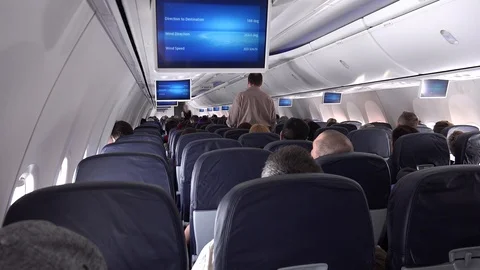 Passengers in an airplane cabin Stock Footage 86530395