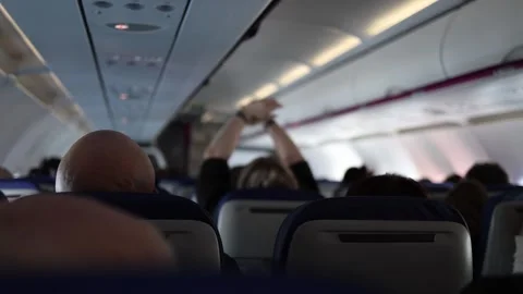 Passengers in airplane cabin interior Stock Footage 331200770