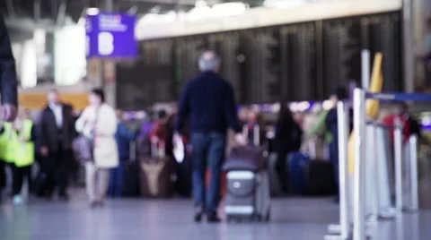 Passengers at an airport walking by. Video stock 44443885