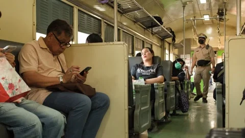 Passengers and Conductor Inside a Commuter Train in Bangkok Thailand Video stock 327830785