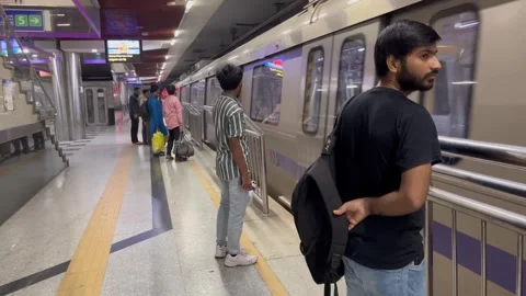 Passengers and Train Arriving and Departing from New Delhi Metro Station Stock Footage 287975778