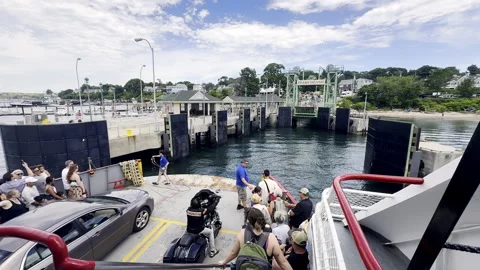 Passengers and vehicles aboard a Casco Bay ferry docking at Peaks Island, Maine Stock Footage 337810460