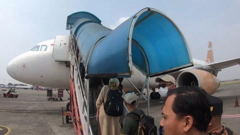 The passengers are getting on the plane Stock Footage 245098507