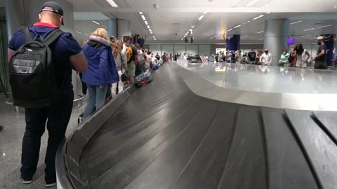 Passengers are looking out for their baggage on arrival in the airport Stock Footage 139663941