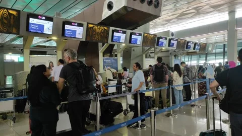 Passengers are queueing for a check in Stock Footage 267853986