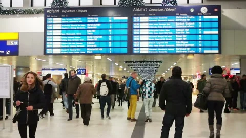 Passengers are standing in front of an information board at the railway station Stock Footage 93537270