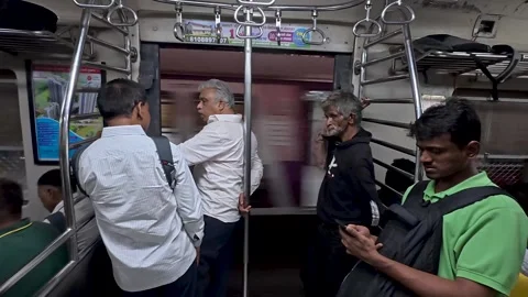 Passengers are standing, talking in local train 動画素材 336704998