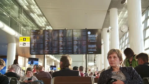 Passengers are waiting to board the plane in the airport hall Stock Footage 238609443
