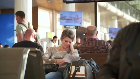 Passengers are waiting to board the plane in the airport hall Stock Footage 238610029