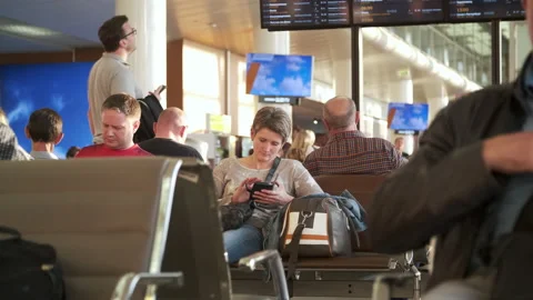 Passengers are waiting to board the plane in the airport hall Stock Footage 238610615