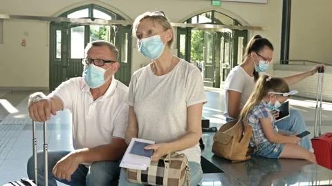 Passengers are waiting for their flight in the waiting room. Everyone has Stock Footage 138099261