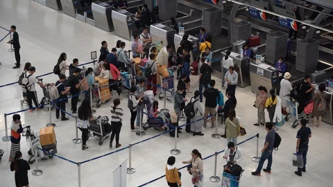 Passengers arrive at check-in counters, Suvarnabhumi Airport, Bangkok, Thailand Stock Footage 123680385