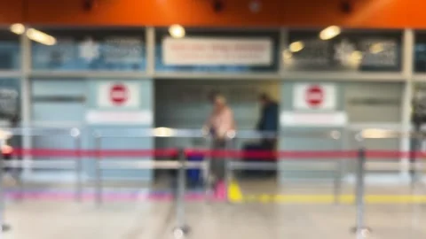 Passengers arriving by plane exit with their luggage through automatic doors. Video stock 311073109