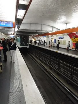 Passengers await the arrival of a train  .. Stock-Fotos