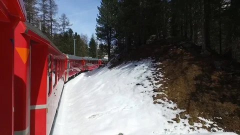 Passengers on Bernina Express, red train of Bernina in the Swiss Alps. Stock Footage 88652288