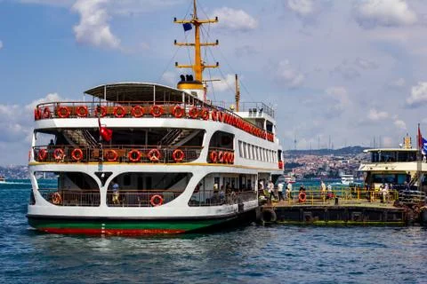 Passengers board a ferry while docked on the banks of the Golden Horn in Ista Stock Photos