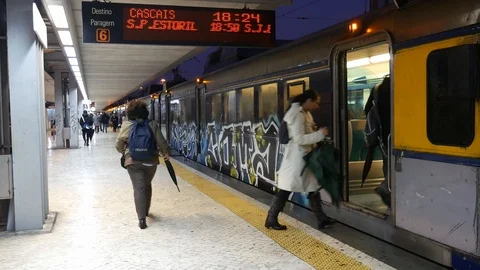 Passengers board a train (comboio) at Cais do Sodre station in Lisbon towards Stock Footage 102142913
