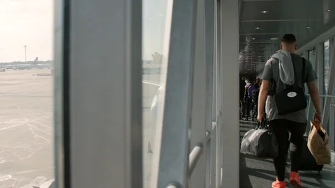 Passengers boarding an Airplane by Docking Sleeve Stock Footage 89413637