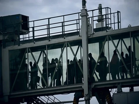 Passengers boarding on airplane through a jetway 스톡 동영상 81121359
