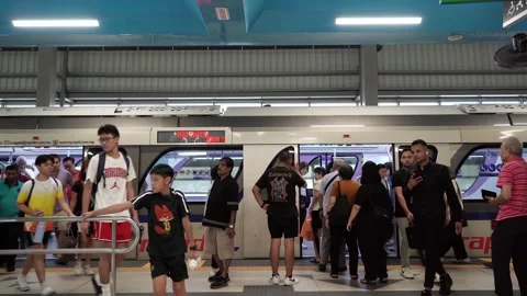 Passengers boarding and exiting the New LRT3 Shah Alam Line train Stock Footage 342338794