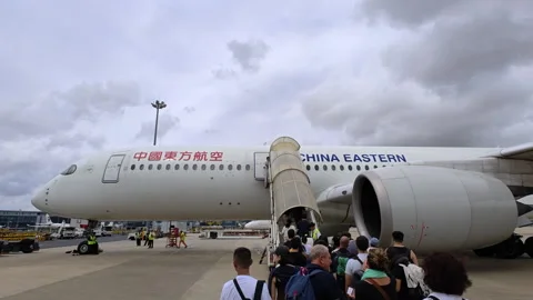 Passengers boarding China Eastern Airlines plane at airport Stock Footage 319274501