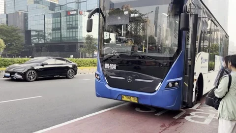 Passengers Boarding a City Bus During Morning Commute in Jakarta Stock Footage 340237564