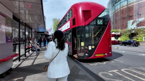 Passengers boarding a red double decker bus number 68 at Waterloo Station Stock Footage 309511154