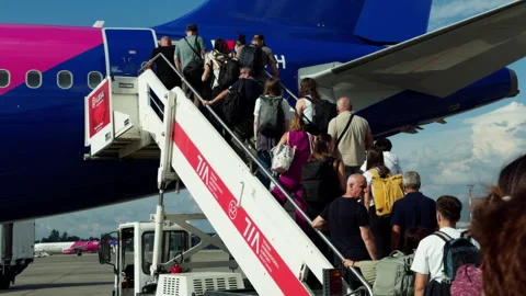 Passengers Boarding a Wizz Air Plane Using Stairs at Tirana Airport Video stock 346522312