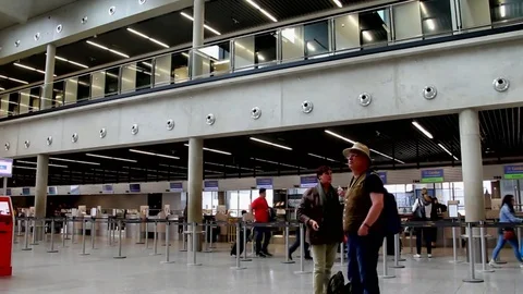 Passengers in Check in zone of one of the halls of the International Airport Stock Footage 74464178