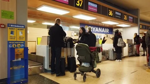 Passengers Checking in at an Airline Desk Stock Footage 100635523
