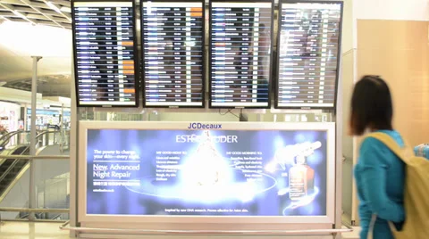 Passengers checking the flight schedule  at Suvarnabhumi Airport Stock Footage 33119714
