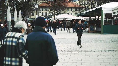 Passengers on cloudy and dry winter day at Viktualinemarkt. Stock Footage 152949630