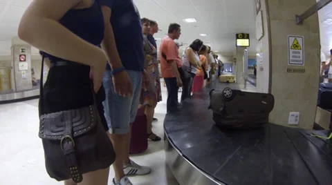 Passengers collect baggage Stock Footage 30489683