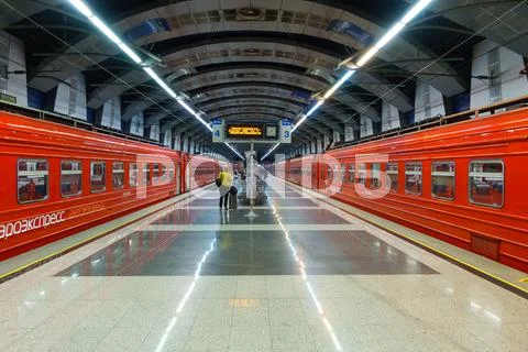 Passengers come to Kievskiy station by Aeroexpress train at night Stock Photos