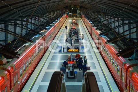 Passengers come to Kievskiy station by Aeroexpress train at night Stock Photos