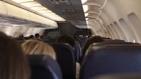 Passengers in comfortable seats of aircraft with the maps on screens in chairs Stock Footage 98288299