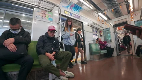 Passengers commuting on a public train in Tokyo, Japan 스톡 동영상 330075833