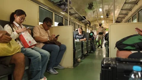 Passengers Commuting on a Train in Bangkok Thailand with Conductor Walking Video stock 327630987