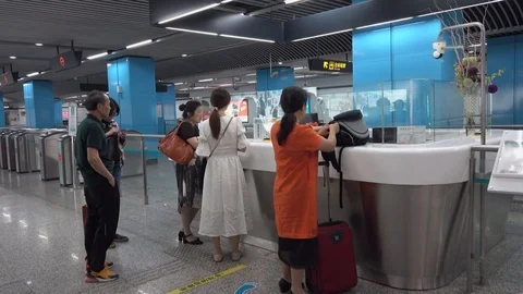 Passengers consult at the subway service window Stock Footage 124589754