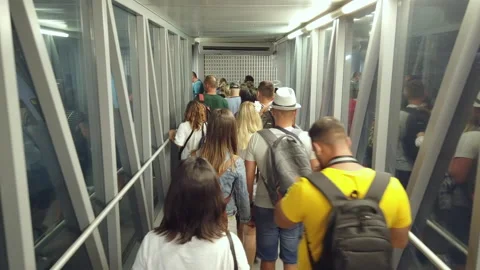 Passengers crowd in boarding bridge get on a plane at the airport Stock Footage 147539084