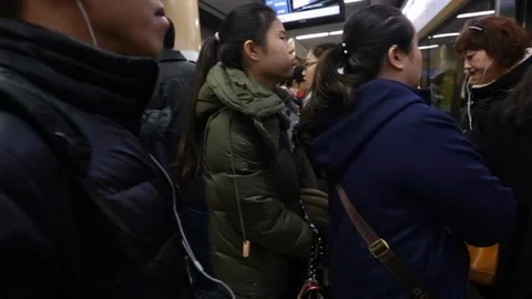 Passengers crowd to enter a subway in Beijing Stock-Footage 128413322