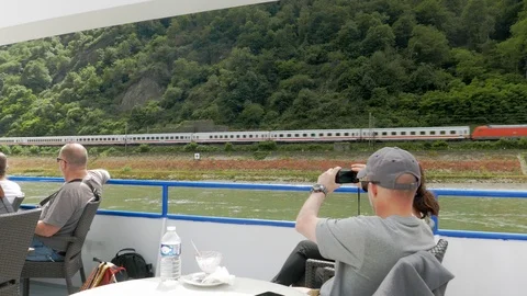 Passengers on the deck of a river cruise contemplating the landscape on the Stock Footage 111133902